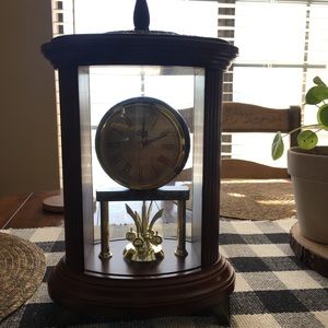 Cherry red wood clock that rotates the little gold balls spin the bottom